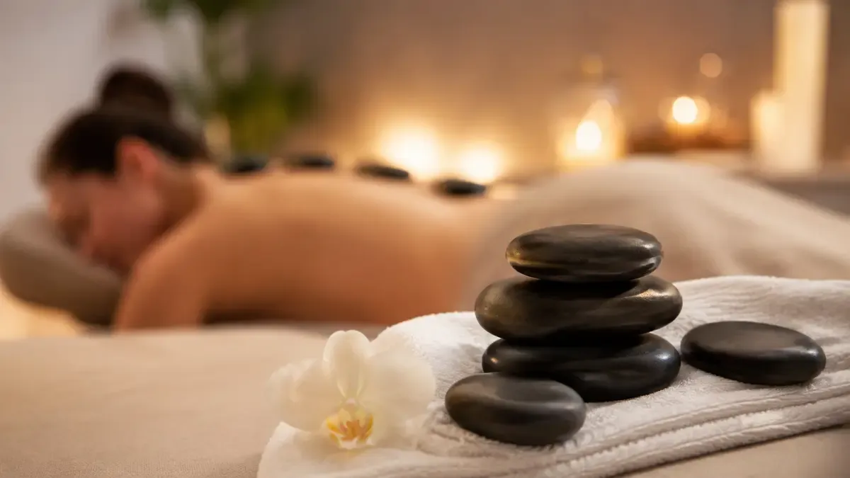 Hot stone massage spa treatment with warm basalt stones placed on a relaxing massage table